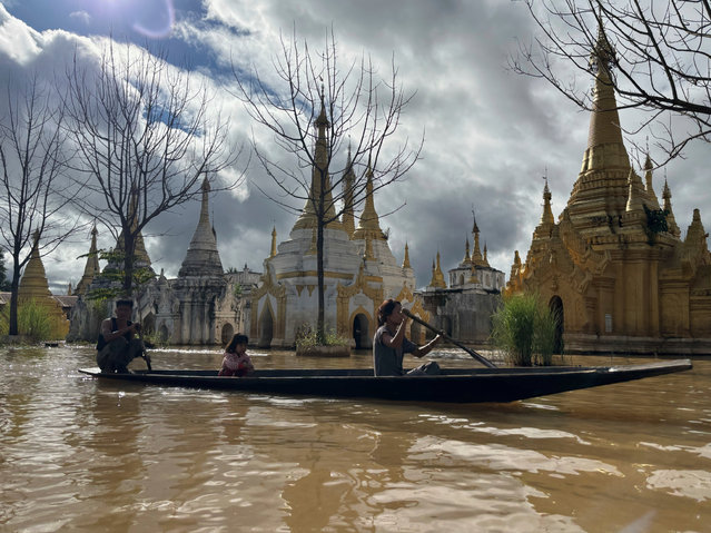Ethnic Inntha people row a boat near pagodas Sunday, September 21, 2025, in Inle Lake, southern Shan State, Myanmar. (Photo by Thein Zaw/AP Photo)