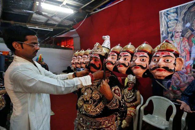 An artist dressed as demon king Ravana gets ready backstage before performing Ramlila, a re-enactment of the life of Hindu Lord Rama, during Vijaya Dashmi or Dussehra festival celebrations in Mumbai, India October 11, 2016. (Photo by Shailesh Andrade/Reuters)