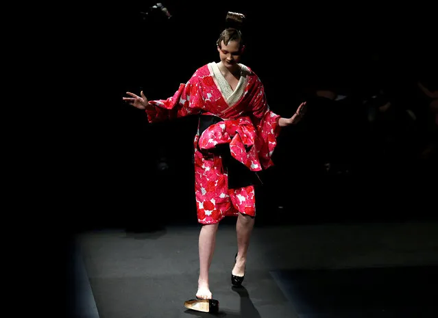 A model struggles with a shoe as she presents a creation by designer Yoshiki, leader of Japan's rock band “X Japan”, from his Spring/Summer 2017 collection for his brand YOSHIKIMONO during Tokyo Fashion Week in Tokyo, Japan October 17, 2016. (Photo by Toru Hanai/Reuters)