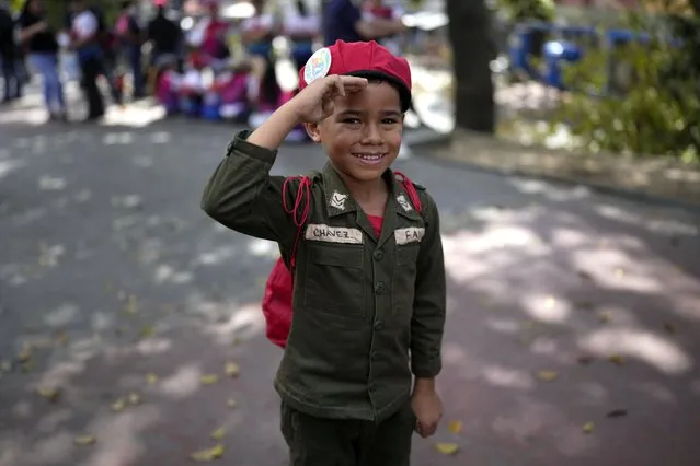 A boy dressed as late Venezuelan President Hugo Chavez salutes as he stands in line to visit Chavez's tomb during commemorations marking the tenth anniversary of his death, outside the Cuartel de la Montaña 4F in Caracas, Venezuela, Sunday, March 5, 2023Ariana Cubillos