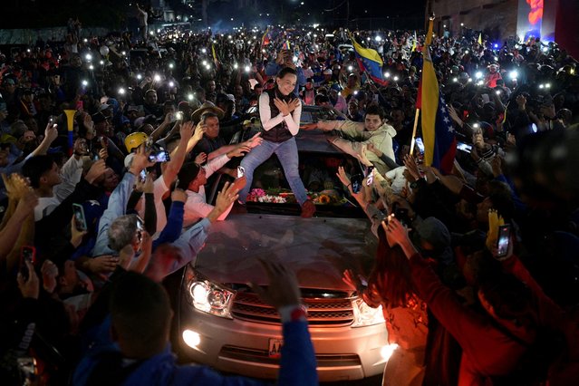 Venezuelan opposition leader Maria Corina Machado greets supporters atop a vehicle during a campaign rally for the presidential election, in Merida state, Venezuela on June 25, 2024. (Photo by Gaby Oraa/Reuters)