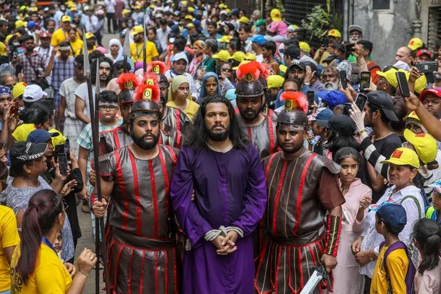 An Indian penitent dressed as Jesus Christ takes part in a reenactment of the station of the cross on Good Friday in Mumbai, India, 07 April 2023. Good Friday is a religious holiday observed by adherents to Christianity, commemorating the crucifixion of Jesus Christ in the Easter week. (Photo by Divyakant Solanki/EPA)