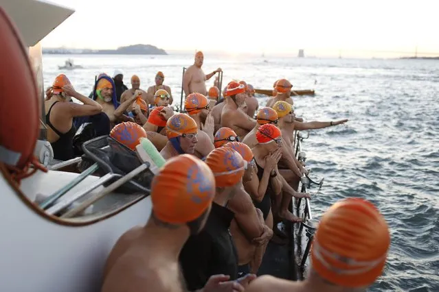 Swimmers with the Dolphin Club wait for the signal to jump into San Francisco Bay near Alcatraz Island during the annual New Year's Day swim to Aquatic Park in San Francisco, California January 1, 2015. (Photo by Stephen Lam/Reuters)