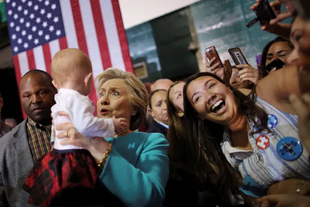 Democratic U.S. presidential nominee Hillary Clinton holds a baby during a campaign rally in Lake Worth, Florida, U.S. October 26, 2016. (Photo by Carlos Barria/Reuters)