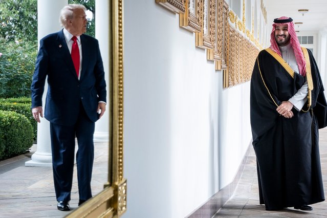 President Donald Trump is reflected in a mirror as he and Saudi Crown Prince Mohammed bin Salman walk along the White House Colonnade on Tuesday, November 18, 2025. The crown prince was welcomed to the White House with all the trappings of a state visit, including a black-tie dinner in the East Room. (Photo by Haiyun Jiang/The New York Times)