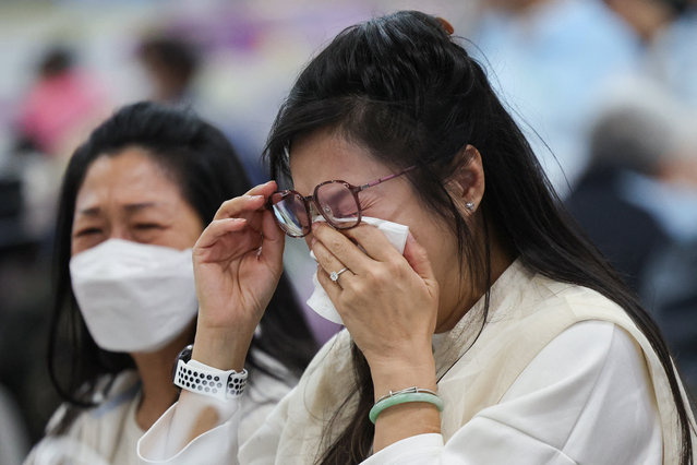 A woman reacts at a temporary shelter, after a fire started across multiple buildings at Wang Fuk Court housing estate, in Tai Po, Hong Kong, China, on November 26, 2025. (Photo by Tyrone Siu/Reuters)
