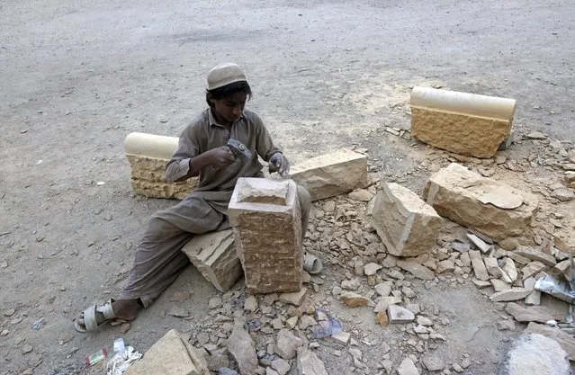 A boy shapes mountain stone to be used in the renovation of a building in Karachi, Pakistan November 13, 2015. (Photo by Akhtar Soomro/Reuters)