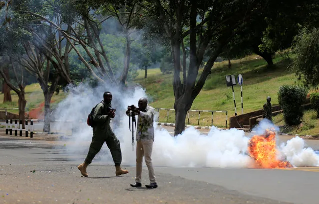 A tear-gas canister explodes next to journalists covering anti-corruption protesters opposing the graft and abuse of funds in public healthcare, during a demonstration in Kenya's capital Nairobi, November 3, 2016. (Photo by Thomas Mukoya/Reuters)