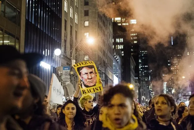 The day after Republican Nominee for President of the United States Donald Trump defeats Democratic Nominee former Secretary of State Hillary Clinton in the general election, thousands of people protest marching up 5th Avenue toward the Trump Tower in midtown Manhattan, New York on Wednesday evening November 9, 2016. (Photo by Melina Mara/The Washington Post)