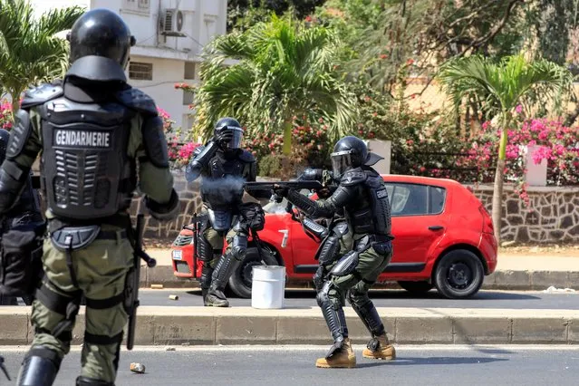 A member of security forces fires a weapon during a clash with supporters of opposition leader Ousmane Sonko in Dakar, Senegal on March 3, 2021. (Photo by Zohra Bensemra/Reuters)