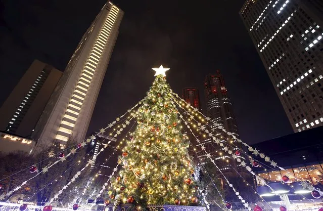 Christmas tree is seen in front of the Tokyo Metropolitan Government Building (2nd R) at Tokyo's Shinjuku business district, Japan, December 6, 2015. (Photo by Yuya Shino/Reuters)