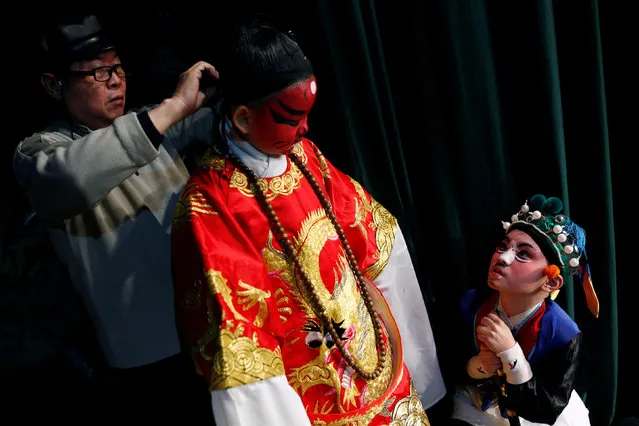 Participants prepare backstage during a traditional Chinese opera competition at the National Academy of Chinese Theatre Arts in Beijing, China, November 26, 2016. (Photo by Thomas Peter/Reuters)