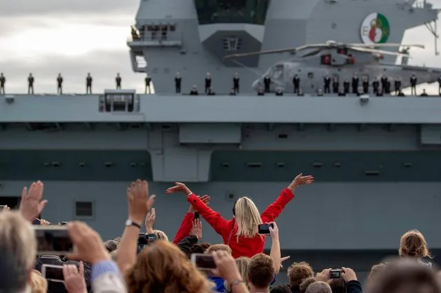 Crowds gather to watch HMS Queen Elizabeth leaving Portsmouth Harbour in Hampshire, United Kingdom on August 18, 2018 for the US to undergo flight trials with the F35B for the first time. (Photo by Steve Parsons/PA Images via Getty Images)