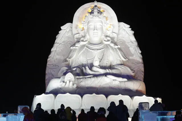 People visit ice sculptures illuminated by coloured lights on the opening day of the Harbin International Ice and Snow Festival in the northern city of Harbin, Heilongjiang province, China, January 5, 2016. (Photo by Aly Song/Reuters)