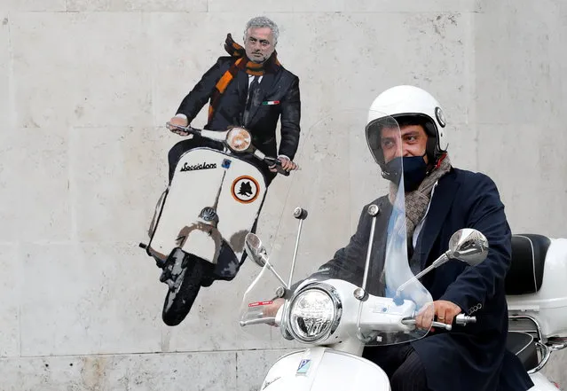 A man drives past a mural depicting new AS Roma coach Jose Mourinho riding a Vespa on a wall in Rome, Italy, May 7, 2021. (Photo by Remo Casilli/Reuters)