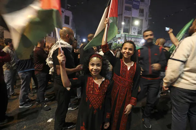 Palestinians celebrate in Ramallah city center in support of the resistance in Gaza, after the cease-fire between the Palestinians and Israel late in the early hours of May 21, 2021, in Ramallah, in the Israeli-occupied West Bank. A ceasefire between Israel and Hamas, the Islamist movement which controls the Gaza Strip, came into force early Friday after 11 days of deadly fighting that pounded the Palestinian enclave and forced countless Israelis to seek shelter from rockets. (Photo by Abbas Momani/AFP Photo)