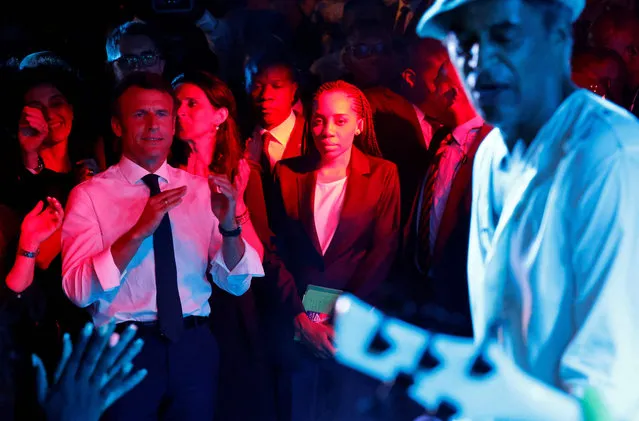 French President Emmanuel Macron watches former French professional tennis player and singer Yannick Noah perform, during a party in Le Village Noah in Yaounde, July 26, 2022. (Photo by Ludovic Marin/AFP Photo)