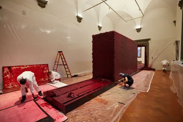 Art fabricators and gallery staff install on October 4, 2023 Svayambhu by Anish Kapoor in Palazzo Strozzi in Florence, Italy for an exhibition of his work which runs until February 2024. Svayambhu comprises a mass of malleable wax which moves on rails along a twenty metre path. (Photo by David Levene/The Guardian)