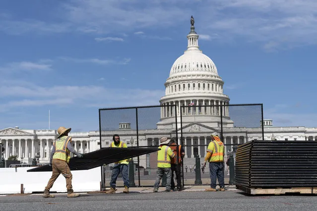 Workers remove the fence surrounding the U.S. Capitol building, six months after it was erected following the Jan. 6 riot at the Capitol, on Saturday, July 10, 2021, in Washington. (Photo by Jose Luis Magana/AP Photo)