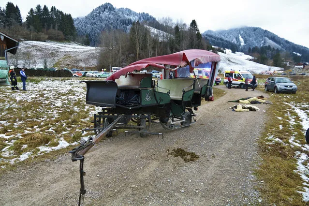 A damaged carriage sits on a path near Pfronten, southern Germany, Tuesday, December 25, 2018. 20 people were injured, two of them seriously, when two horse-drawn carriages collided during a Christmas day outing. The two carriages, each with 10 passengers, were approaching a rail crossing single file when the first carriage halted. The second did not and overturned during the collision. (Photo by Benjamin Liss/DPA via AP Photo)