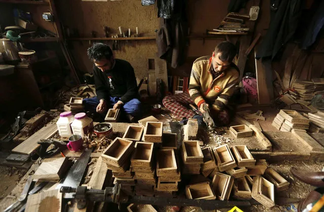 Kashmiri woodwork craftsmen work at their workshop in Srinagar, summer capital of Indian Kashmir, 03 February 2016. People associated with walnut woodwork complain of economic hardships  because of low wages, which has resulted in decline in their business. (Photo by Farooq Khan/EPA)
