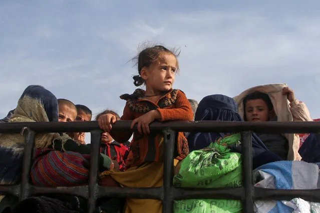 An Afghan family travel on a truck with their belongings as they head back to Afghanistan, after Pakistan gave a final warning to undocumented immigrants to leave, at the Friendship Gate of Chaman Border Crossing along the Pakistan-Afghanistan Border in Balochistan Province, in Chaman, Pakistan on November 4, 2023. (Photo by Naseer Ahmed/Reuters)