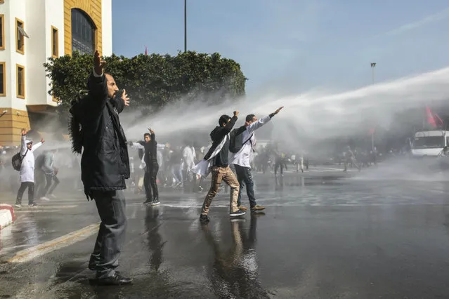Security forces use water cannons to disperse protesting teachers, in Rabat, Morocco, Wednesday, February 20, 2019. Moroccan police fired water cannons at protesting teachers who were marching toward a royal palace and beat people with truncheons amid demonstrations around the capital Wednesday. (Photo by Mosa'ab Elshamy/AP Photo)