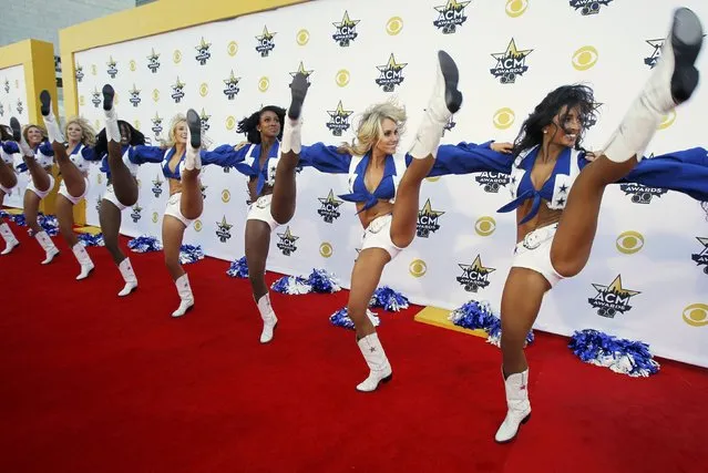 The Dallas Cowboy cheerleaders perform on the red carpet at the 50th Annual Academy of Country Music Awards in Arlington, Texas April 19, 2015. (Photo by Mike Stone/Reuters)