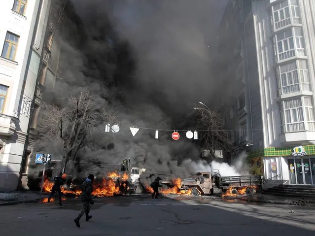 Anti-government protesters clashed violently with police in central Kiev, a day after Moscow moved to cement its influence over Ukraine with $2 billion in cash to shore up the former Soviet state's heavily indebted economy. (Photo by Sergei Chuzavkov/AP Photo)