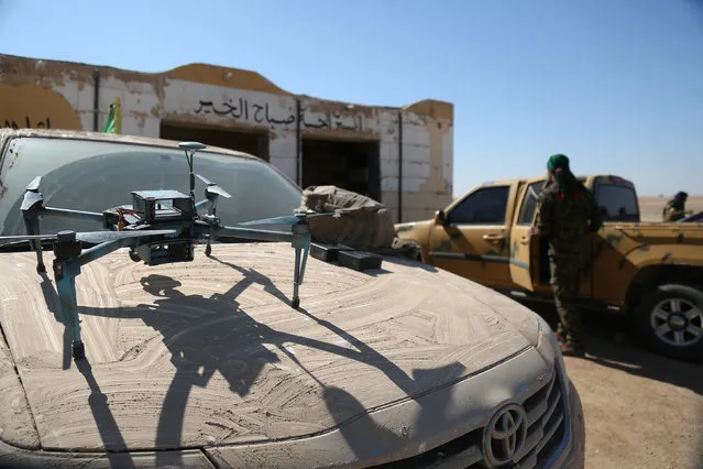 A drone is pictured as a Syrian Democratic Forces (SDF) fighter gets into a military vehicle in northern Deir al-Zor province ahead of an offensive against Islamic State militants, Syria February 21, 2017. (Photo by Rodi Said/Reuters)