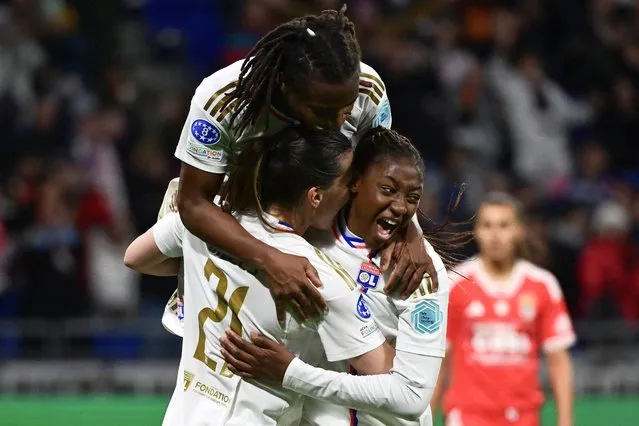 Lyon's French forward #11 Kadidiatou Diani (R) celebrates with teammates after scoring her team's third goal during the UEFA Women's Champions League quarter final second leg football match between Olympique Lyonnais and SL Benfica at The Groupama Stadium in Decines-Charpieu, central-eastern France on March 27, 2024. (Photo by Olivier Chassignole/AFP Photo)