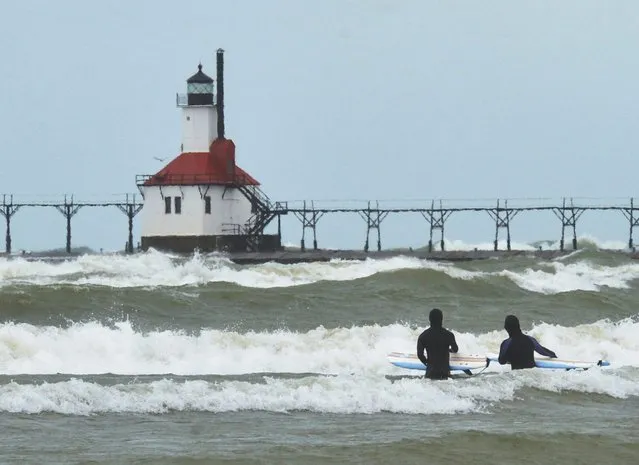 Winter returns to Southwest Michigan Wednesday, February 28, 2024, as surfers brave cold and windy conditions along Lake Michigan in St. Joseph, Mich. (Photo by Don Campbell/AP Photo)