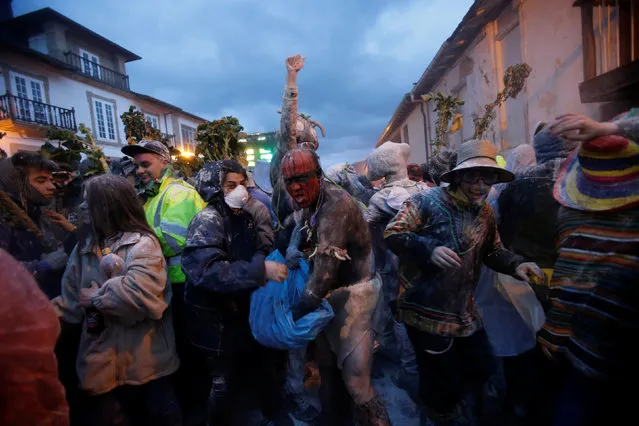 Revellers participate in a flour fight during the “O Entroido” festival in Laza village, Spain February 27, 2017. (Photo by Miguel Vidal/Reuters)