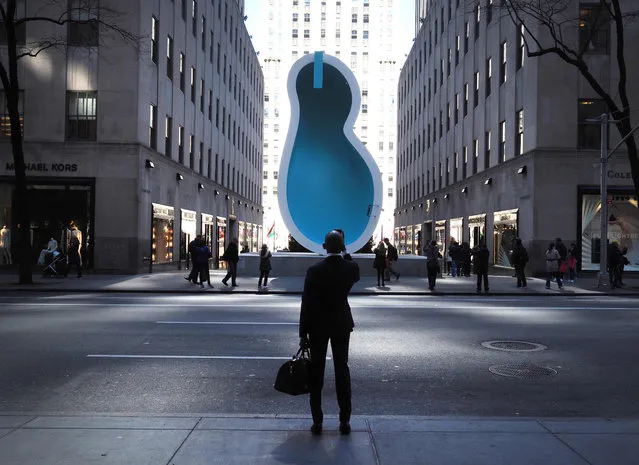 A large-scale new public art work, the sculpture of a 30-ft swimming pool by artist duo Elmgreen & Dragset, titled “Van Gogh's Ear” is on display April 13, 2016 at the Fifth Avenue entrance to the Channel Gardens at Rockefeller Center in New York. Elmgreen & Dragset: Van Gogh's Ear will be free to the public and on view April 13 through June 3, 2016. The exhibition is organized by Public Art Fund and Tishman Speyer. (Photo by Timothy A. Clary/AFP Photo)