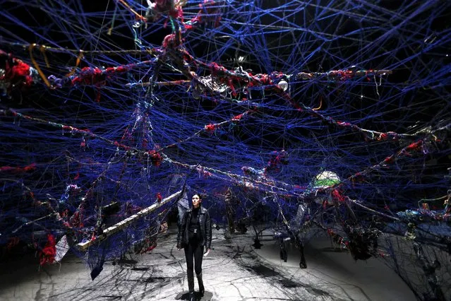 A person passes through an installation during the opening of the exhibition “Ground Break” by artist Nari Ward, at Pirelli HangarBicocca, in Milan, Italy on March 26, 2024. (Photo by Claudia Greco/Reuters)