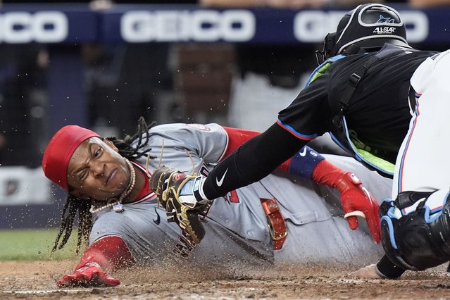 Miami Marlins catcher Nick Fortes, right, is unable to tag out Washington Nationals' CJ Abrams as he scores during the eighth inning of a baseball game, Friday, April 26, 2024, in Miami. Abrams and Trey Lipscomb scored on a single by Joey Meneses. (Photo by Wilfredo Lee/AP Photo)