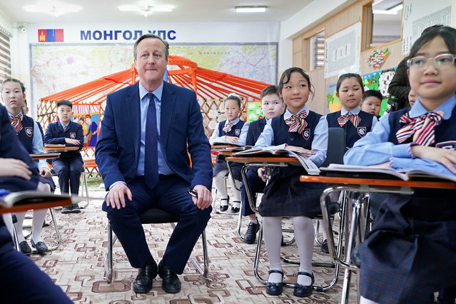 British Foreign Secretary David Cameron meets pupils and takes part in an English lesson at School No.23, during his tour of the Central Asia region, in Ulaanbaatar, Mongolia, on April 26, 2024. (Photo by Stefan Rousseau/Pool via Reuters)