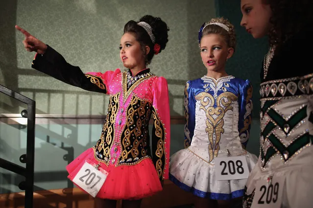 Competitors in an 11/12 yrs old Girls Category wait to perform backstage at the World Irish Dance Championship on April 13, 2014 in London, England. The 44th World Irish Dance Championship is currently running at London's Hilton London Metropole hotel, and will host approximately 5,000 dancers competing in solo, Ceili, modern figure choreography and dance drama categories during the week long event. (Photo by Dan Kitwood/Getty Images)