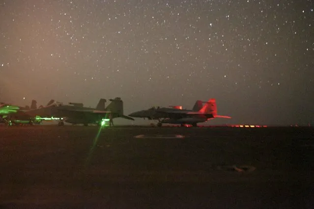 In this photo taken on Sunday, May 26, 2019 and released by the U.S. Navy, F/A-18 Super Hornets sit secured on the flight deck of the Nimitz-class aircraft carrier USS Abraham Lincoln in the Arabian Sea. (Photo by Mass Communication Specialist 3rd Class Jeremiah Bartelt/U.S. Navy via AP Photo)