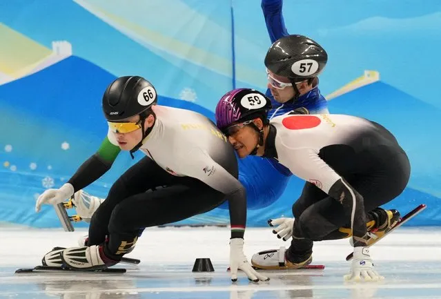 John-Henry Krueger, left, of Hungary leads Kazuki Yoshinaga of Japan and Denis Airapetian of the Russian Olympic Committee as they collide during their heat of the men's 1,000-meter the short track speedskating competition at the 2022 Winter Olympics, Saturday, Feb. 5, 2022, in Beijing. (Photo by Aleksandra Szmigiel/Reuters)