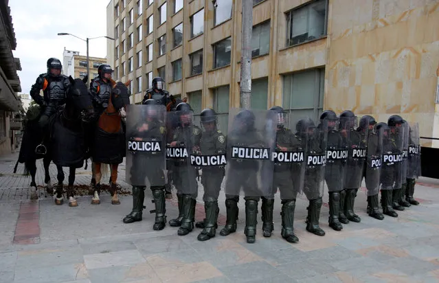 Riot policemen stand during May Day protests in Bogota, Colombia, May 1, 2016. (Photo by Jon Nazca/Reuters)