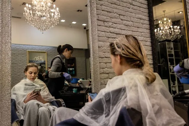 A woman gets her hair done at a beauty salon on February 16, 2022 in Kyiv, Ukraine. (Photo by Chris McGrath/Getty Images)
