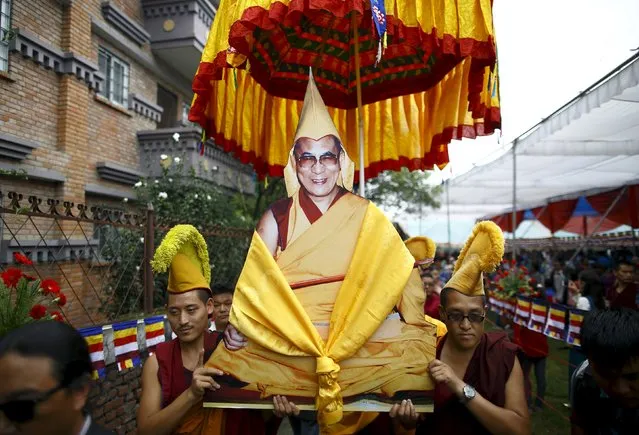 Tibetan monks carry a portrait of Dalai Lama during his 80th birthday celebrations in Kathmandu July 6, 2015. Nepal ceased issuing refugee papers to Tibetans in 1989 and recognizes Tibet to be a part of China. (Photo by Navesh Chitrakar/Reuters)