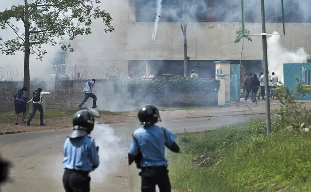 Police fire tear gas towards opposition supporters as they run away during a protest in downtown Nairobi, Kenya Monday, May 9, 2016. (Photo by Ben Curtis/AP Photo)