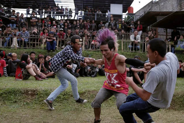 Punk community members dance during a punk music festival in Bandung, Indonesia West Java province, March 23, 2017. (Photo by Reuters/Beawiharta)