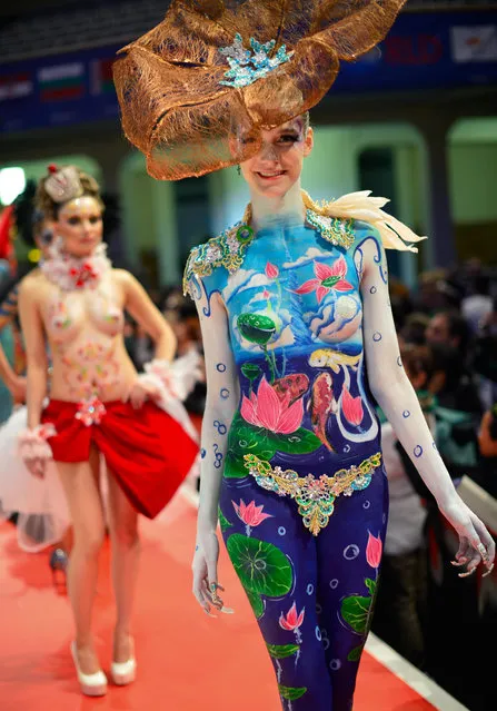 A model poses on the catwalk after the contest “Body Painting” of the OMC Hairworld World Cup on May 4, 2014 in Frankfurt am Main, Germany. The OMC Hairworld World Cup will be held in Frankfurt from 3 to 5 May 2014, parallel to the Hair and Beauty 2014 fair. Around 1.250 participants from 50 countries fight in different contest for the titles. (Photo by Thomas Lohnes/Getty Images)