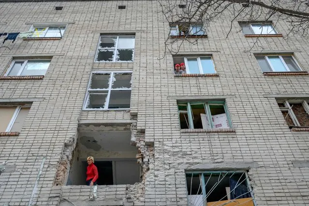 A Ukrainian woman looks out from a damaged building which was hit by a Russian mortar in Mykolaiv, 100km away from Odessa, western Ukraine on March 8, 2022. Odessa, which Ukraine fears could be the next target of Russia's offensive in the south, is the country's main port and is vital for its economy. But the city of one million people close to the Romanian and Moldovan borders also holds a special place in the Russian imagination. (Photo by Bulent Kilic/AFP Photo)