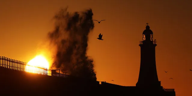 Waves crash over the pier wall in North Shields as the sun rises on the first day of meteorological spring in Tynemouth, England on March 1, 2017. (Photo by Owen Humphreys/PA Wire)