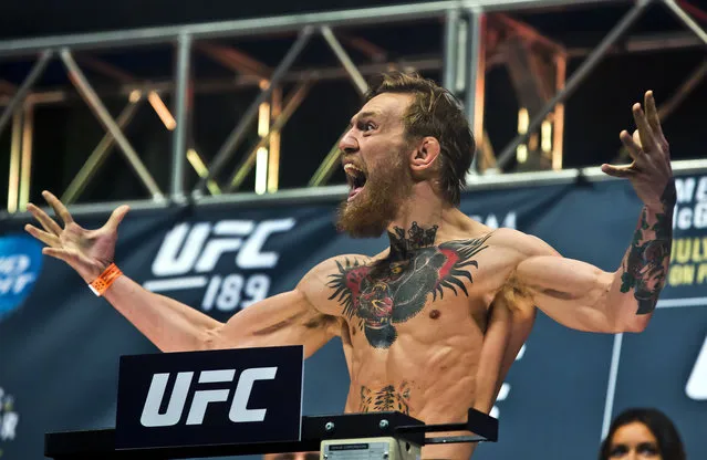 Featherweight Conor McGregor lets out a yell to his fans during the weigh in for UFC 189, Friday, July 10, 2015 at the MGM Grand Garden Arena in Las Vegas. Conor McGregor's boastful Irish charm and exceptional trash-talking skills have turned him into a UFC star, and his reward is a featherweight title fight with Chad Mendes on Saturday night. (Photo by L. E. Baskow/Las Vegas Sun via AP Photo)