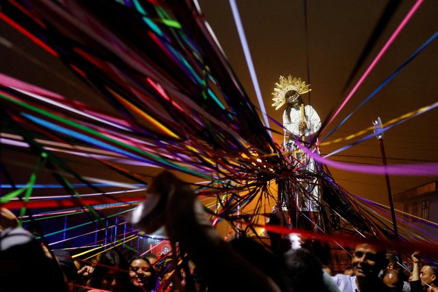 Catholics carry a statue of Jesus Nazareno during a procession known as “Jesus Nazareno of the Ribbons”, where people tie ribbons to the statue to symbolise promises they make to Jesus, during Holy Week in Cartago, Costa Rica on April 5, 2023. (Photo by Mayela Lopez/Reuters)